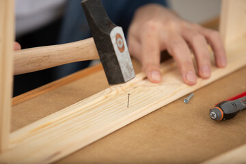 carpenter uses a tool in hand