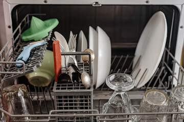 Clean dishes, glassware and cutlery in dishwasher machine after washing