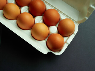 Yellow chicken egg on a light and dark background.