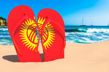 Flip flops with Kyrgyz flag on the beach. Kyrgyzstan resorts, vacation, tours, travel packages concept. 3D rendering