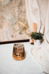 Close-up of iced coffee served on black table at cafe​