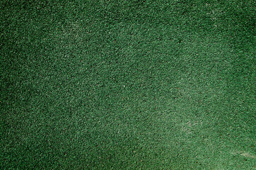 rubber crumb texture, green background in fine crumbs selective focus