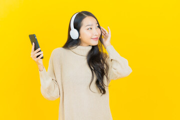 Portrait beautiful young asian woman with headphone and smart phone for listen music