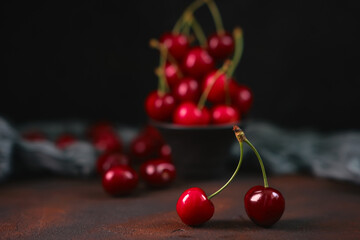 Composition of sweet cherries on a dark background with water drops top view
