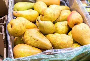 Fresh pears in the cardboard box at the grocery store