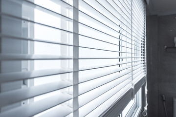white curtain roll behind a glass window.