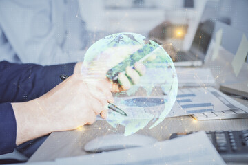 Double exposure of man's hands holding and using a phone and social network theme drawing.