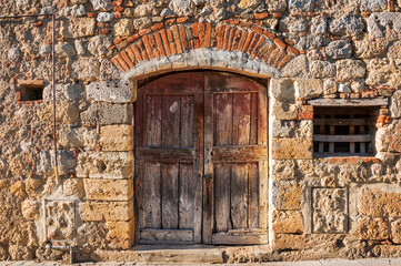 Old italian wooden door in Monteriggioni, Italy