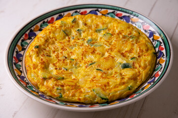 Traditional Spanish omelette with zucchini and potatoes.