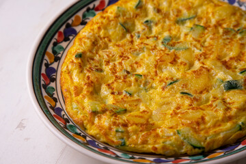 Traditional Spanish omelette with zucchini and potatoes.