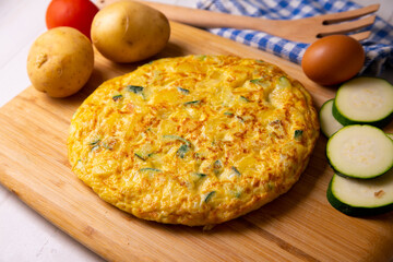 Traditional Spanish omelette with zucchini and potatoes.
