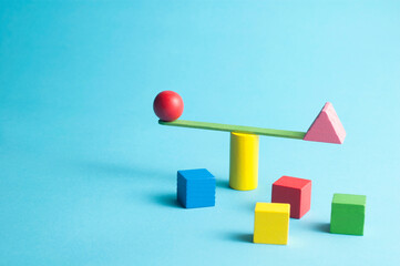 Minimal concept with a stick swingscale and colorful geometric figures - Powered by Adobe