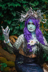 Obraz premium fabulous dark mermaid with blue skin in the forest close up