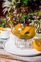 teapot green tea with lemon, mint and cinnamon food photo