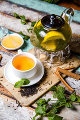 teapot green tea with lemon, mint and cinnamon food photo