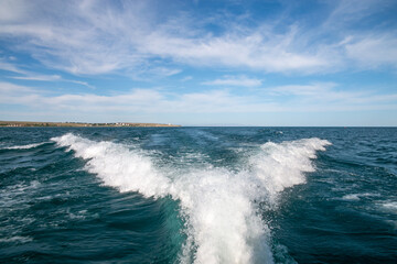 Fototapeta premium foam, spray and waves from a fast yacht. leaves behind waves and a white trail