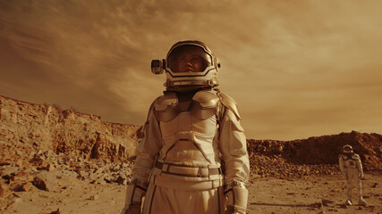 Female astronaut admiring terrain of Mars