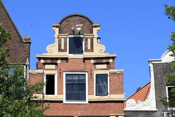 Amsterdam Oudezijds Voorburgwal Canal Traditional House Facade Close Up Against a Blue Sky