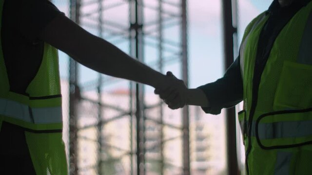 A Construction workers shaking hands in agreement in a building under development in Boca Raton Florida 
