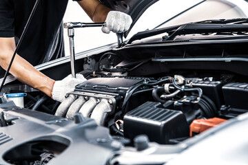 Car care maintenance and servicing, Close-up hand technician auto mechanic using the wrench to repairing change spare part car engine problem. Concepts of check and during periodic inspection service.