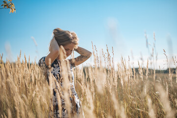 Beauty Romantic Girl Outdoors. Beautiful Teenage Model girl Dressed in Casual Dress on the Field in Sun Light. Glow Sun, Sunshine