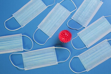 Viral Coronavirus Bacteria And Protective Medical Disposable Masks On A Blue Background. Concept Of...