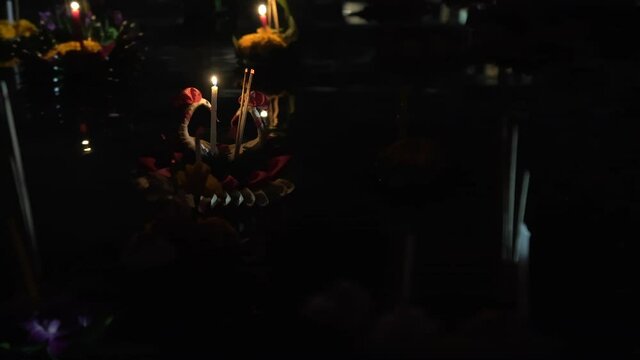 Make a wish, float the Krathong into the water in the night for loy krathong festival ,bangkok.