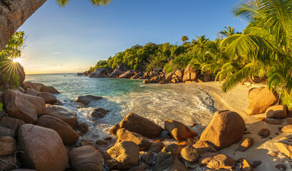 sunset at tropical beach anse lazio on praslin on the seychelles