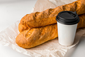 Fresh baked french baguettes with a cup of coffee