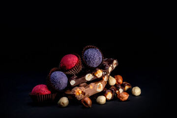 Chocolate bar, crushed pieces of dark chocolate and nuts. Praline Chocolate sweets