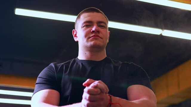 man clap hands with powder in gym get ready to working out
