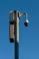 360 Degree CCTV security camera fixed on a pole on a blue sky background - security, big brother...