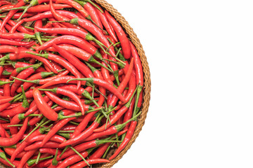 Many red hot chili pepper arranged on a wooden basket