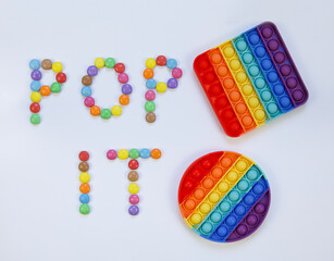Rainbow poppy it fidget. Multicolour letters.