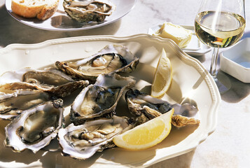 A Plate of Oysters (Seafood). Served with Lemon, Oyster and Champagne.