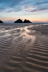 Fototapeta na wymiar Absolutely beautiful landscape images of Holywell Bay beach in Cornwall UK during golden hojur sunset in Spring
