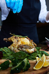 chicken broiler with herbs on a round wooden board