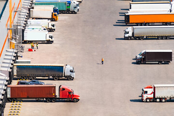 Modern logistics warehouse of goods. Large cargo trucks load goods for further transportation to...