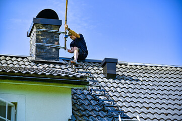 a man taking down an old tv-antenna