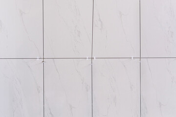 white plastic tile leveling use for install ceramic on cement floor in new room. square background full frame