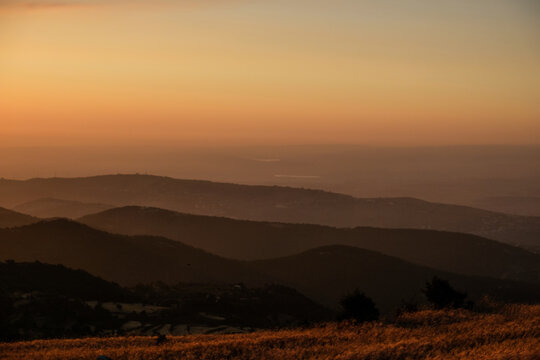 Sunset in front of the silhouette of the mountains and the wheat fields of North Lebanon