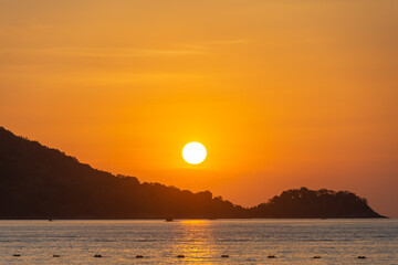 beautiful sunset at Patong beach, Phuket, Thailand. soft focus and noise.