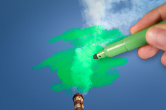 Man painting green pollution from a chimney