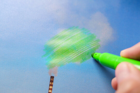 Man painting green pollution from a chimney