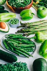 Healthy organic green food, assortment of fresh vegetables: Avocado, lettuce, broccoli, green peas, cucumber, pepper, celery, kale, asparagus and other.