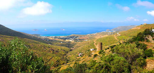 Fototapeta na wymiar panoramic view of the bay of Gavrio on the island of Andros, famous island of the Cyclades, with in the foreground the Agios Petros tower, the construction of which dates from the 4th century BC
