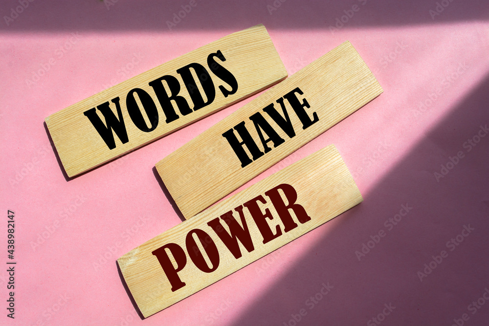 Wall mural The phrase Words Have Power on wooden blocks laying on pink background. 