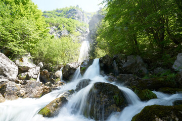 Naklejka na ściany i meble Waterfall in the mountains in Theth in the Albanian alps