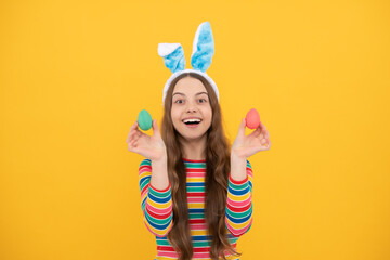 happy easter teen girl in bunny ears holding painted eggs for holiday egg hunt, easter holiday.