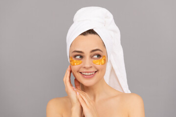 happy girl with terry towel use facial golden eye patch for skin, healthy skin